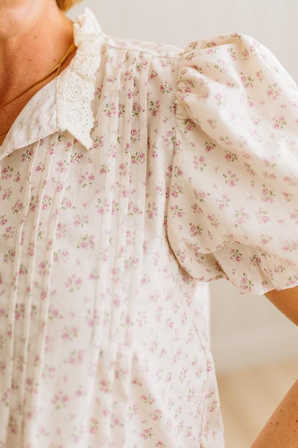Close-up of a floral blouse with a blurred background