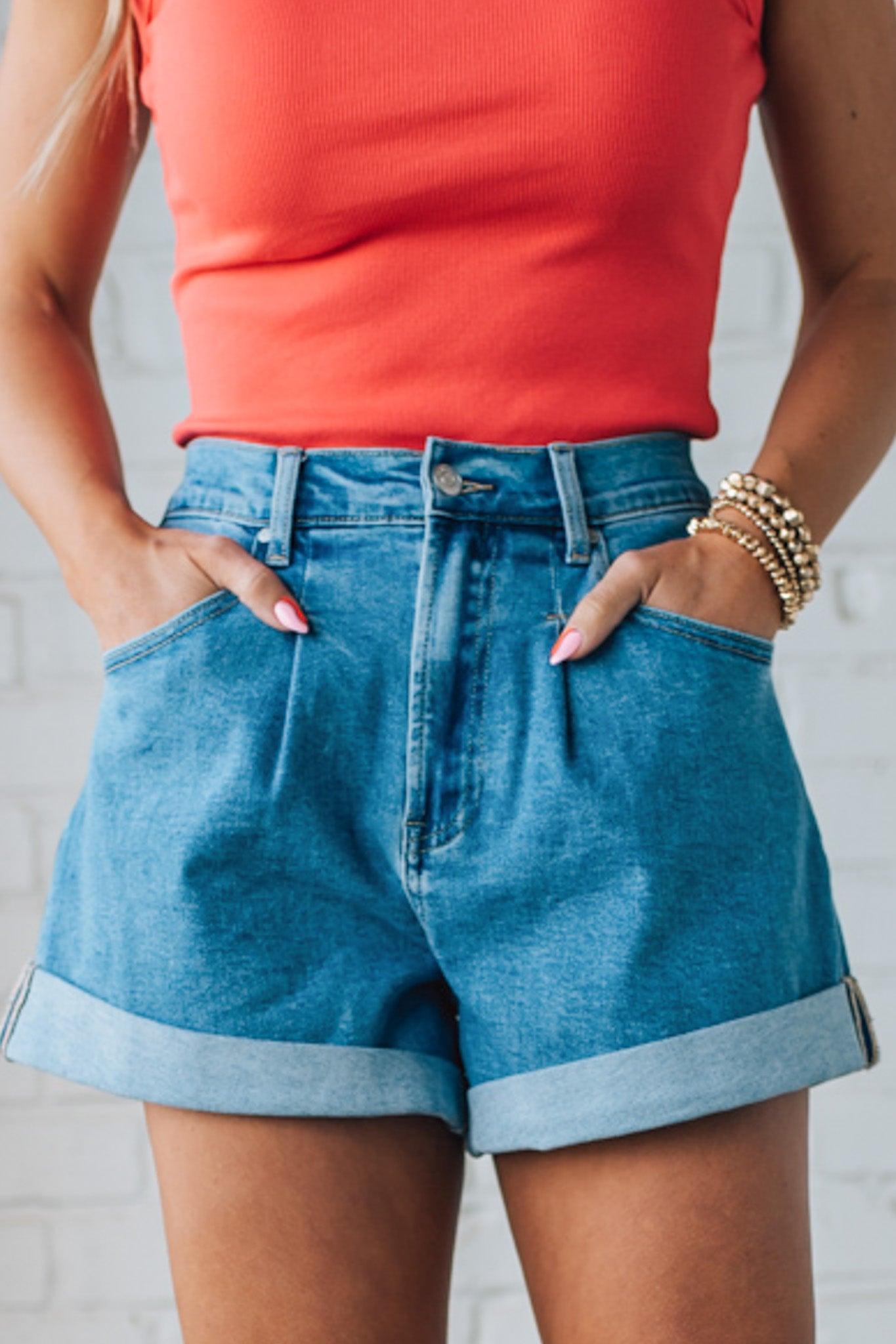 Blonde woman in a red top wearing medium blue Comfort Stretch Loose Fit Denim Shorts.
