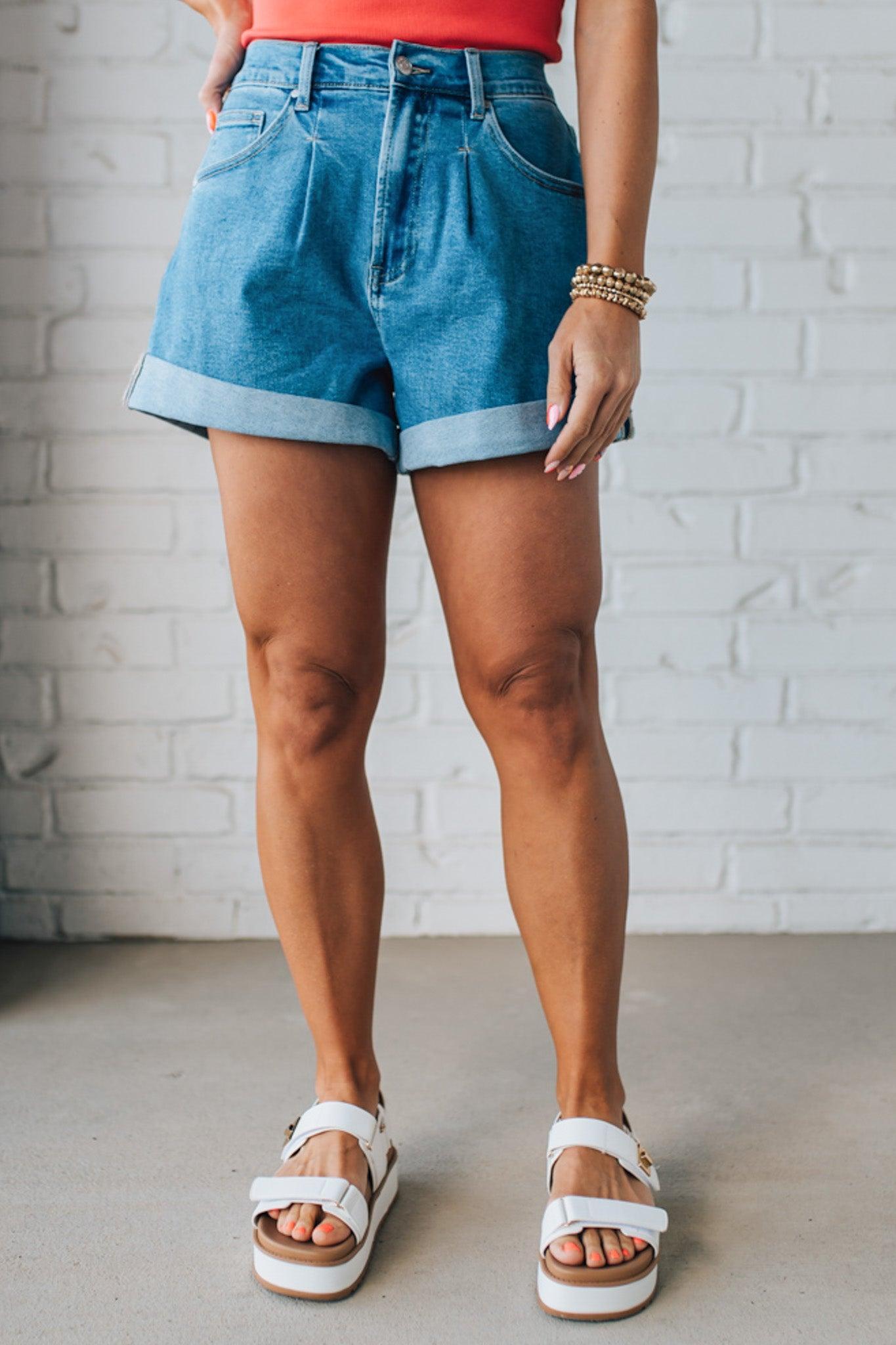 Blonde woman in a red top wearing medium blue Comfort Stretch Loose Fit Denim Shorts.