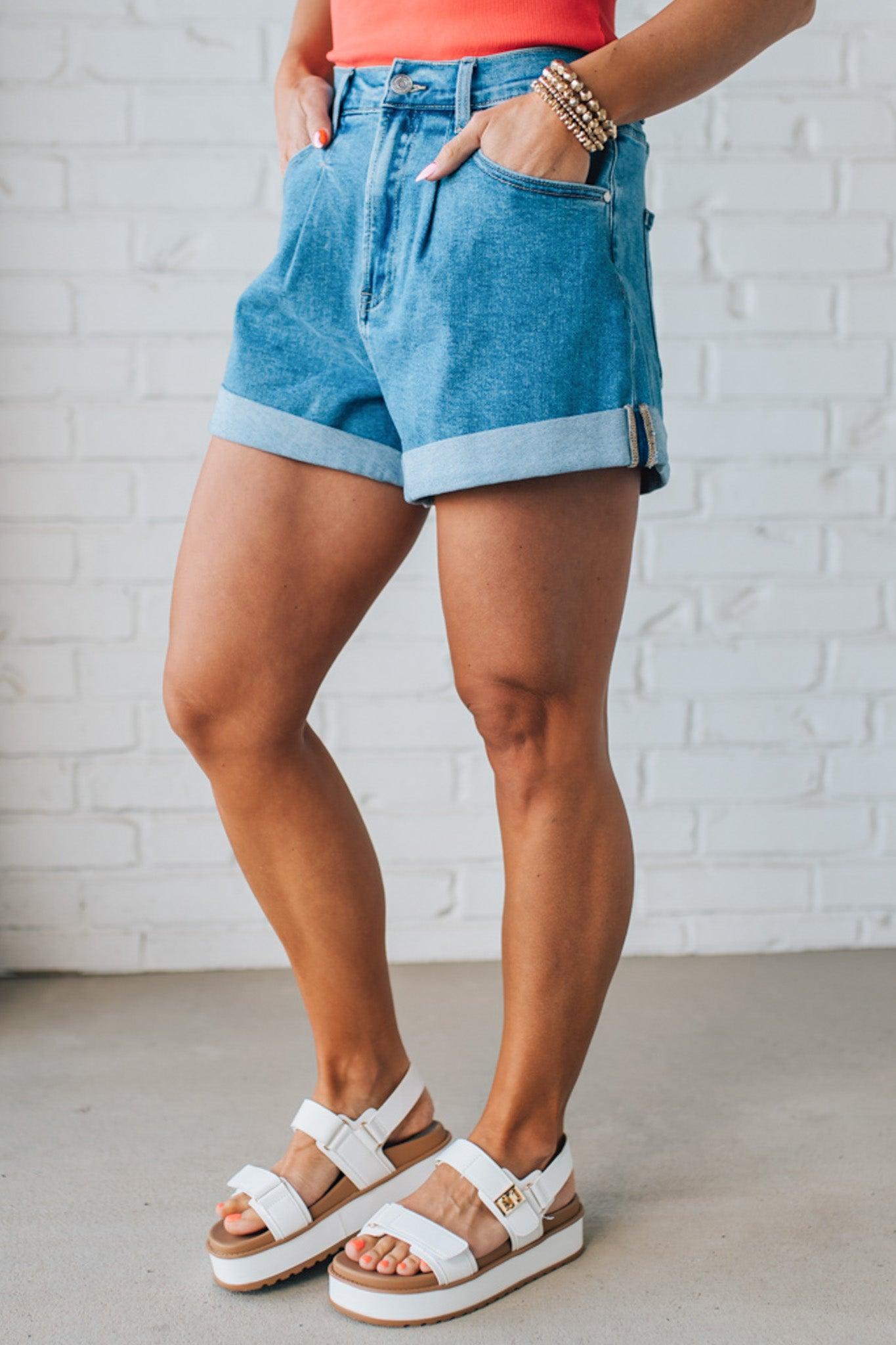 Blonde woman in a red top wearing medium blue Comfort Stretch Loose Fit Denim Shorts.