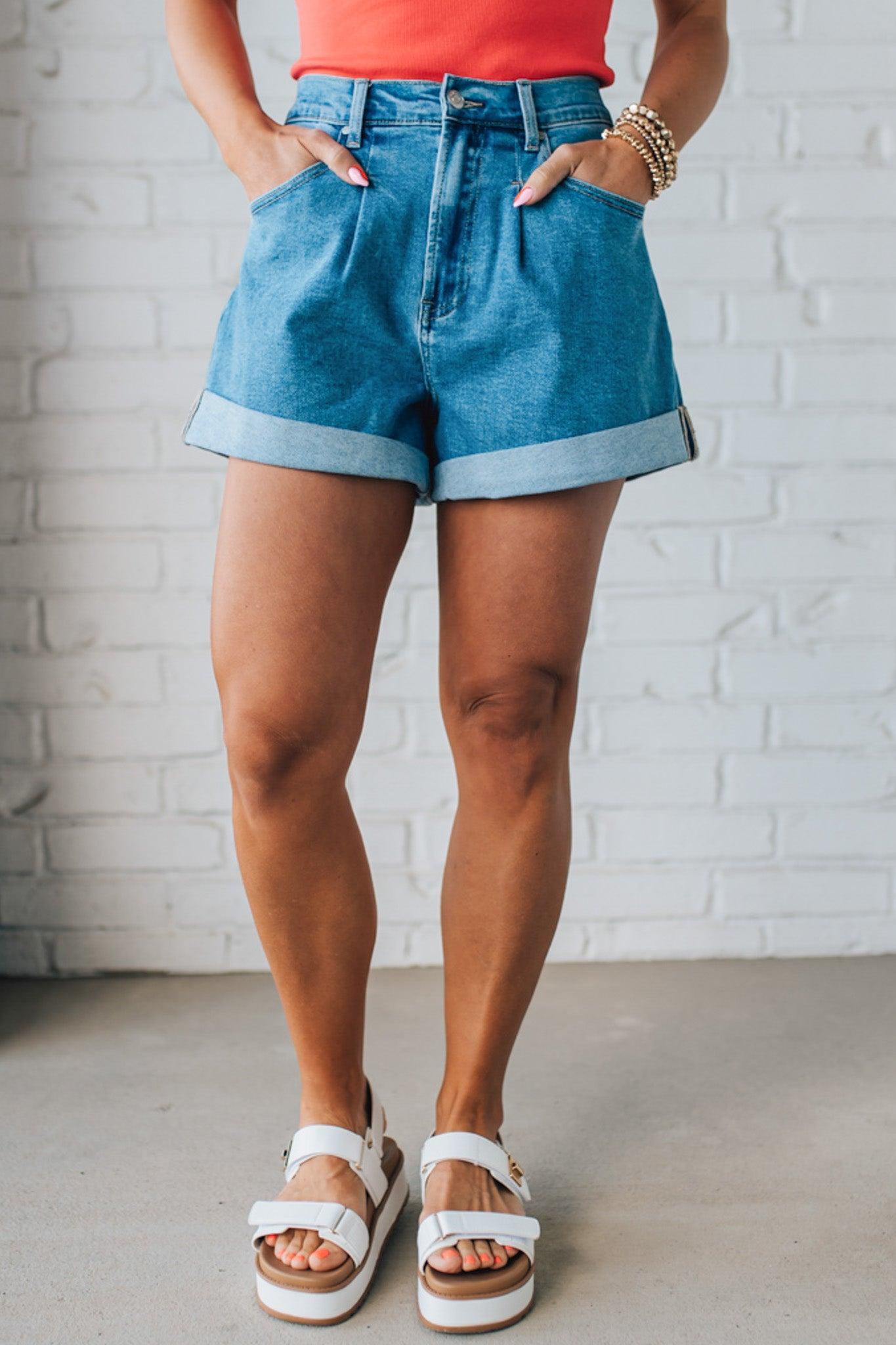 Blonde woman in a red top wearing medium blue Comfort Stretch Loose Fit Denim Shorts.