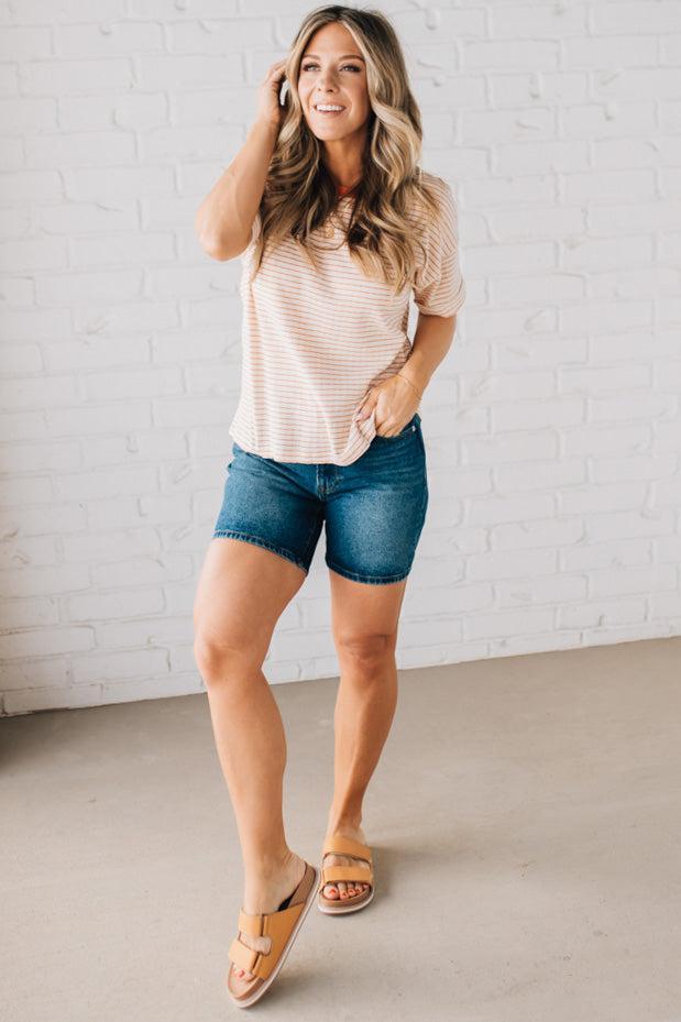BLONDE WOMAN WEARING A COLOR TRIMMED ROUND NECK, ROLL UP SHORT SLEEVE, POINTELLE STRIPE TOP.