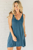 Blonde woman wearing a knee length ribbed kit dress.