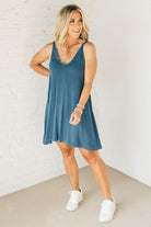 Blonde woman wearing a knee length ribbed kit dress.