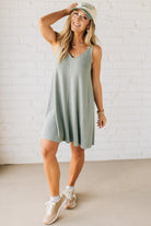 Blonde woman wearing a knee length ribbed kit dress.