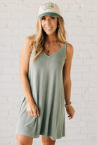 Blonde woman wearing a knee length ribbed kit dress.