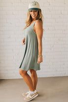 Blonde woman wearing a knee length ribbed kit dress.