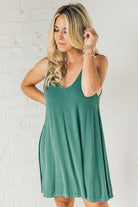 Blonde woman wearing a knee length ribbed kit dress.