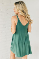 Blonde woman wearing a knee length ribbed kit dress.