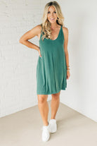 Blonde woman wearing a knee length ribbed kit dress.