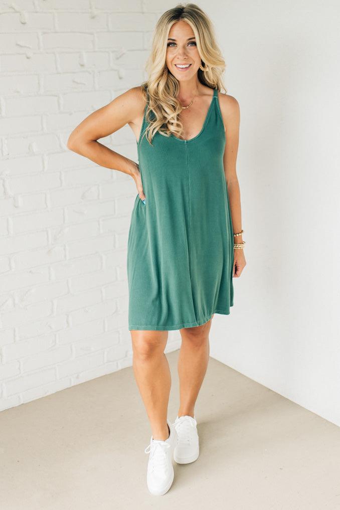 Blonde woman wearing a knee length ribbed kit dress.