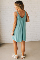 Blonde woman wearing a knee length ribbed kit dress.