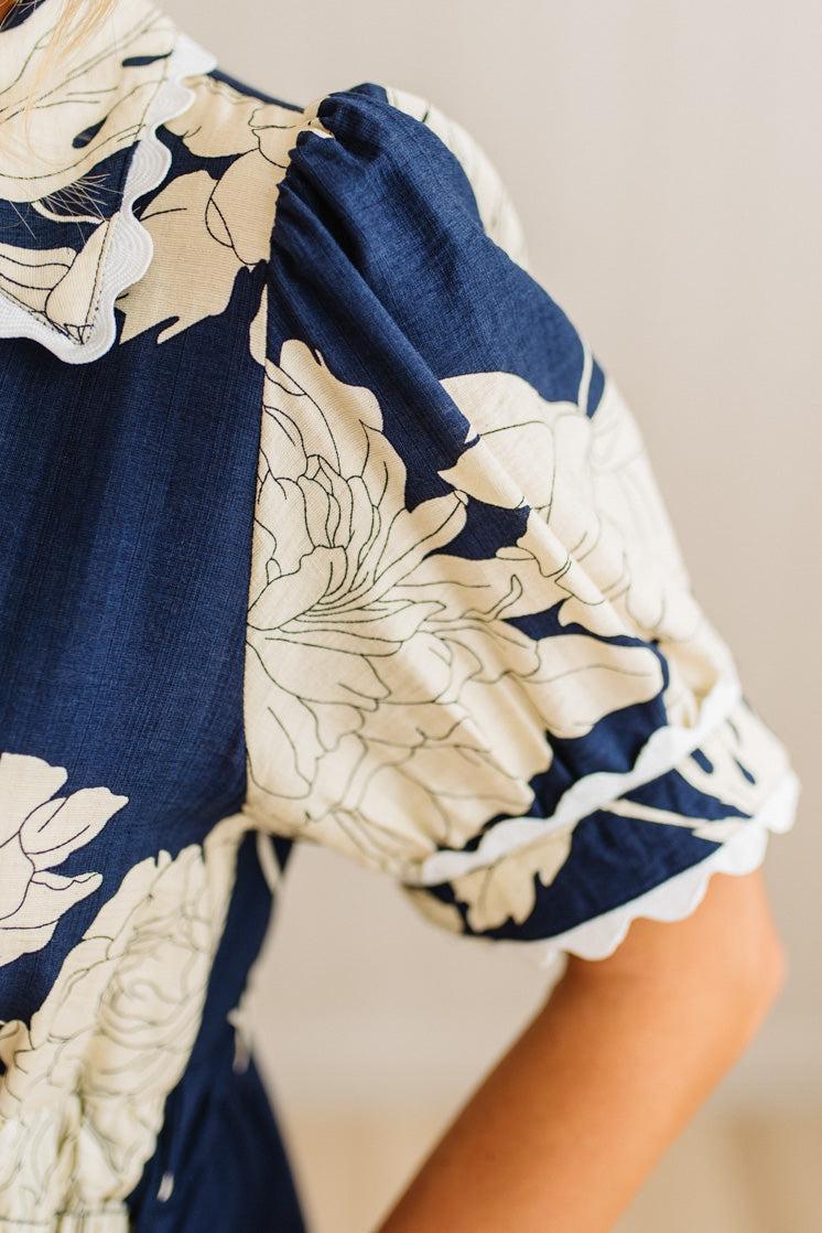 Navy blue and beige floral dress with a close-up of the neckline.