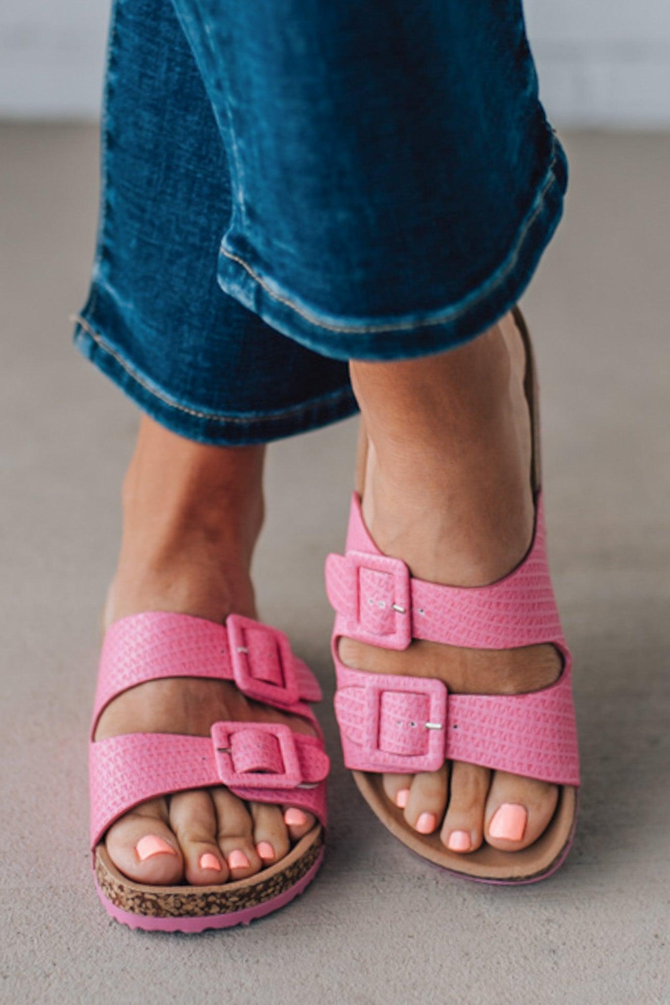 girl modeling a casual dark pink textured sandal with double straps and a cork bottom