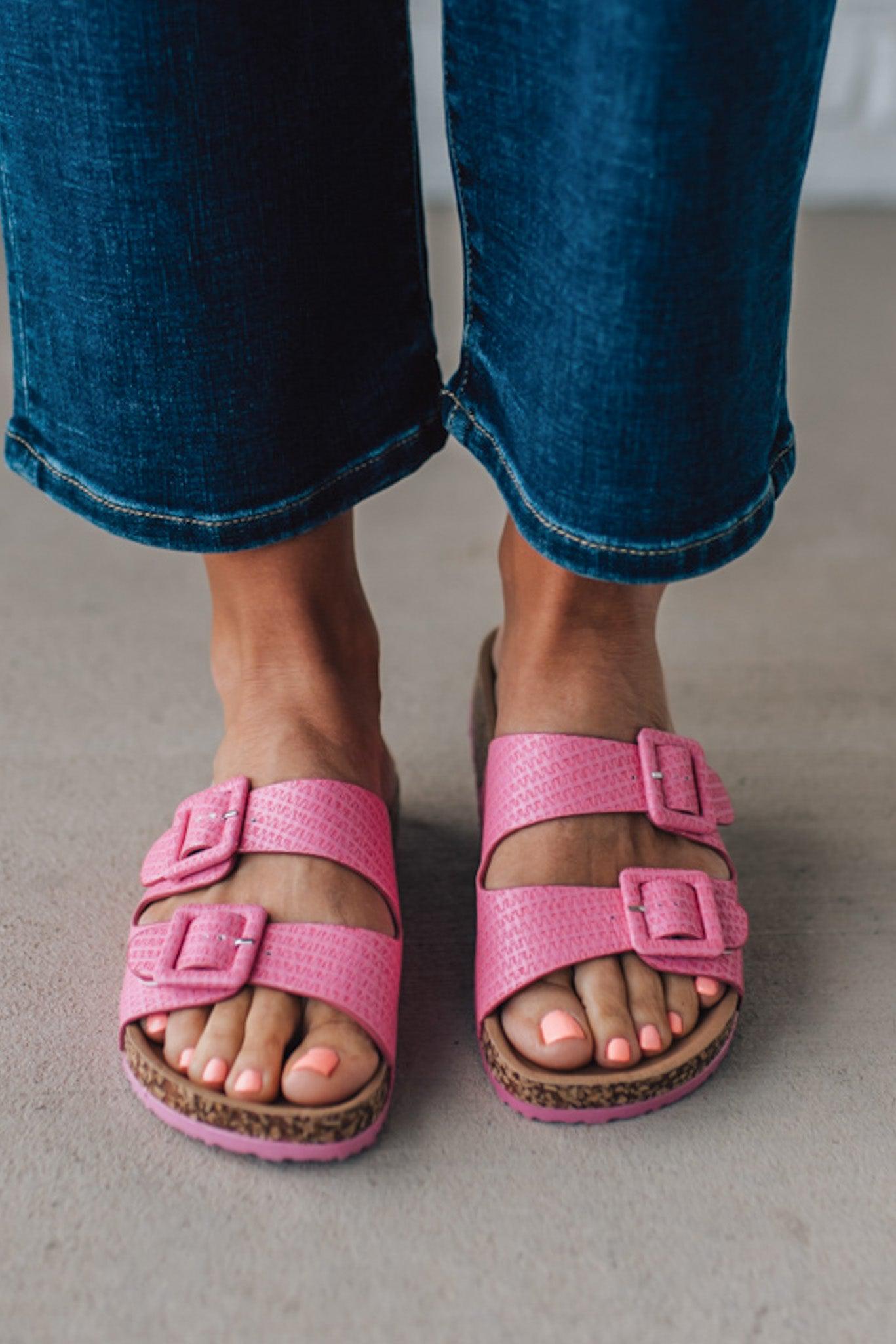 girl modeling a casual dark pink textured sandal with double straps and a cork bottom