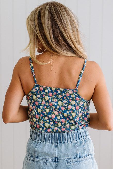 Blonde Woman Wearing a V Neck Floral Printed Tank Top.