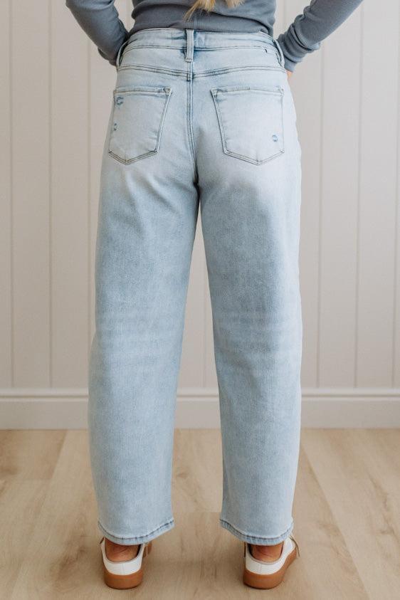 Light blue jeans worn by a person against a neutral background