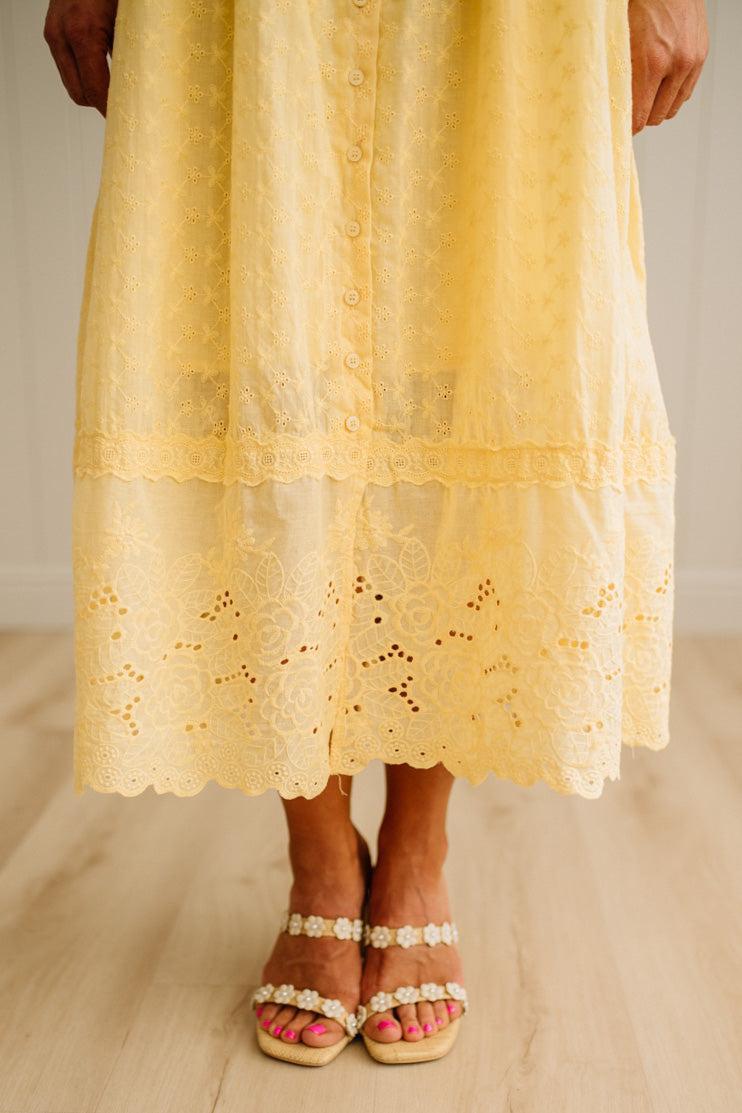 Yellow lace dress with a plain background
