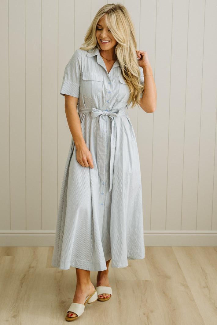 Blonde Woman Wearing a Striped Cotton Button Down Maxi Dress in Light Blue and White Fine Stripes