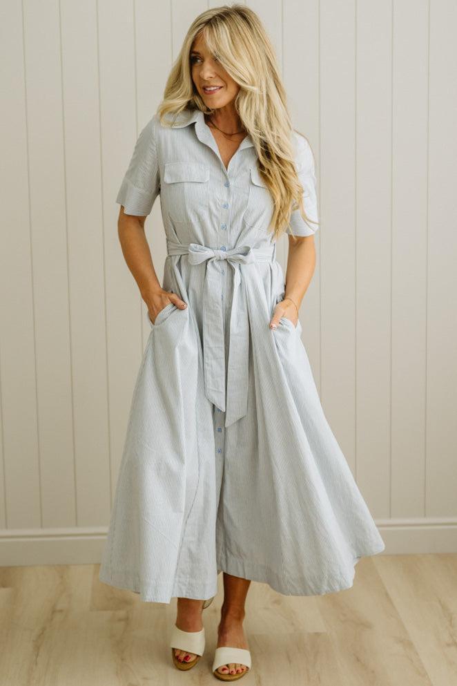 Blonde Woman Wearing a Striped Cotton Button Down Maxi Dress in Light Blue and White Fine Stripes