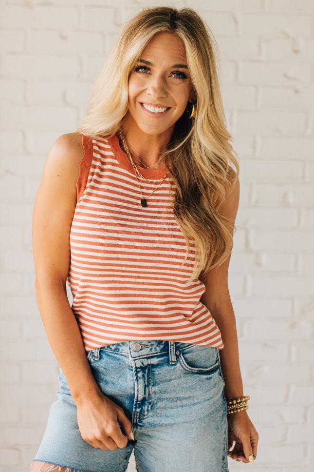 BLONDE WOMAN WEARING A CONTRAST COLOR SCALLOP FINISHED, CREW NECK, SLEEVELESS STRIPED SWEATER.