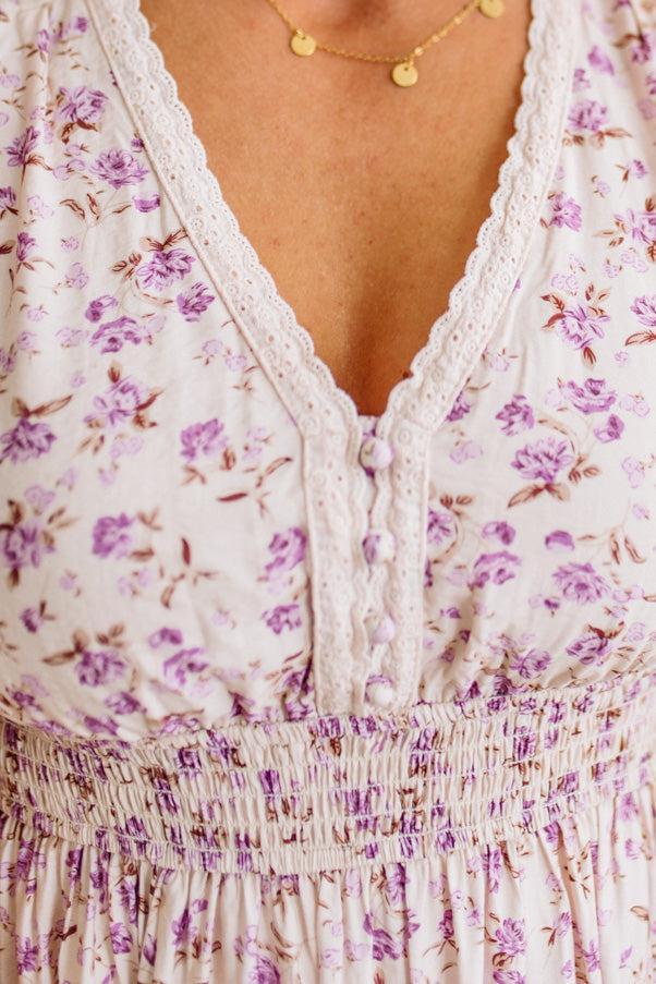 Close-up of a floral dress with a V-neckline and lace details.