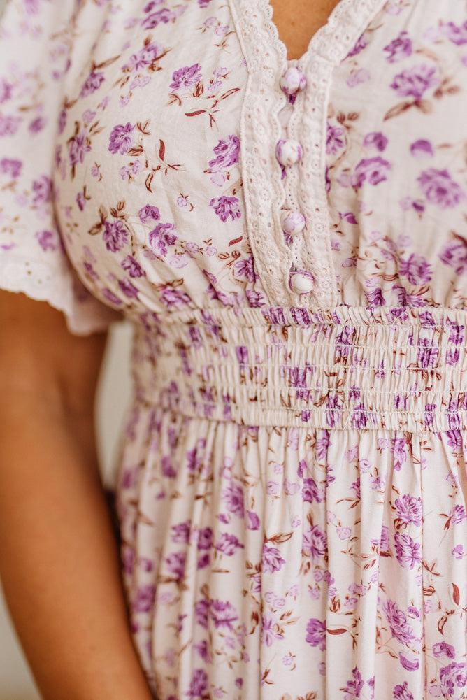 Close-up of a floral dress with a focus on the fabric and pattern.