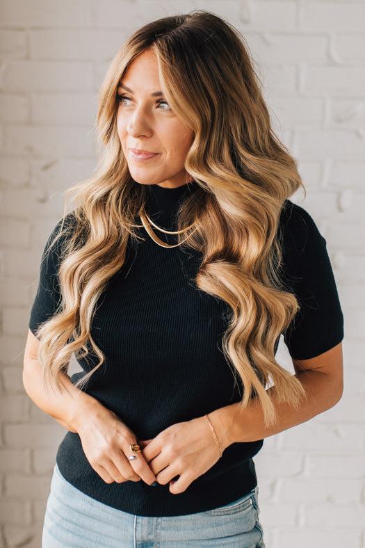 Blonde girl modeling a half sleeve mini ribbed fitted top with mock neck