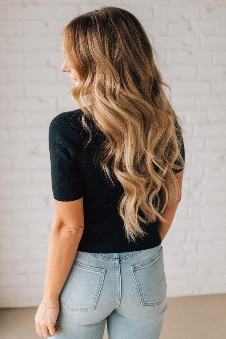 Blonde girl modeling a half sleeve mini ribbed fitted top with mock neck