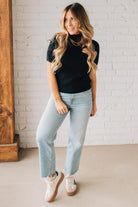 Blonde girl modeling a half sleeve mini ribbed fitted top with mock neck