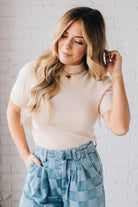 Blonde girl modeling a half sleeve mini ribbed fitted top with mock neck