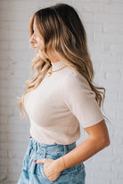 Blonde girl modeling a half sleeve mini ribbed fitted top with mock neck