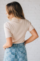 Blonde girl modeling a half sleeve mini ribbed fitted top with mock neck