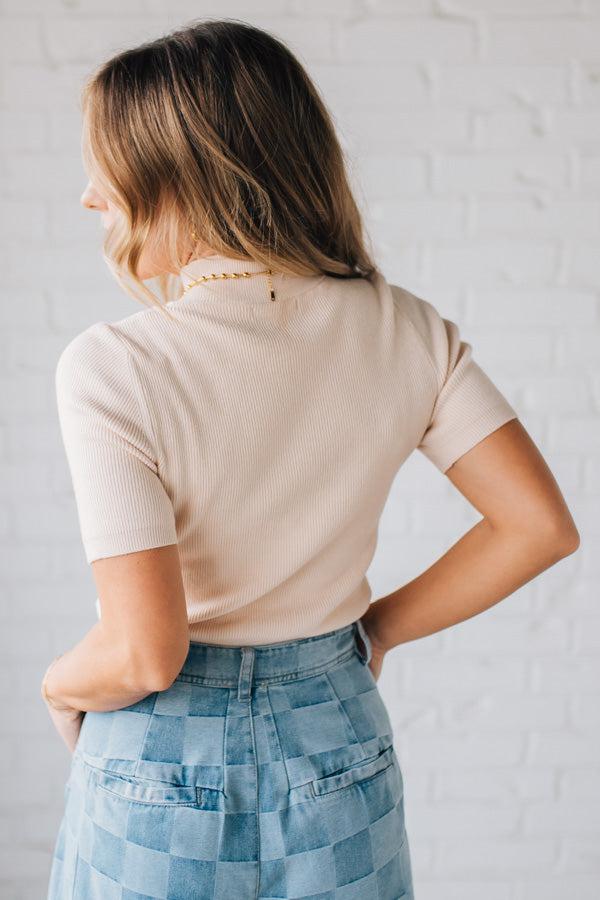 Blonde girl modeling a half sleeve mini ribbed fitted top with mock neck