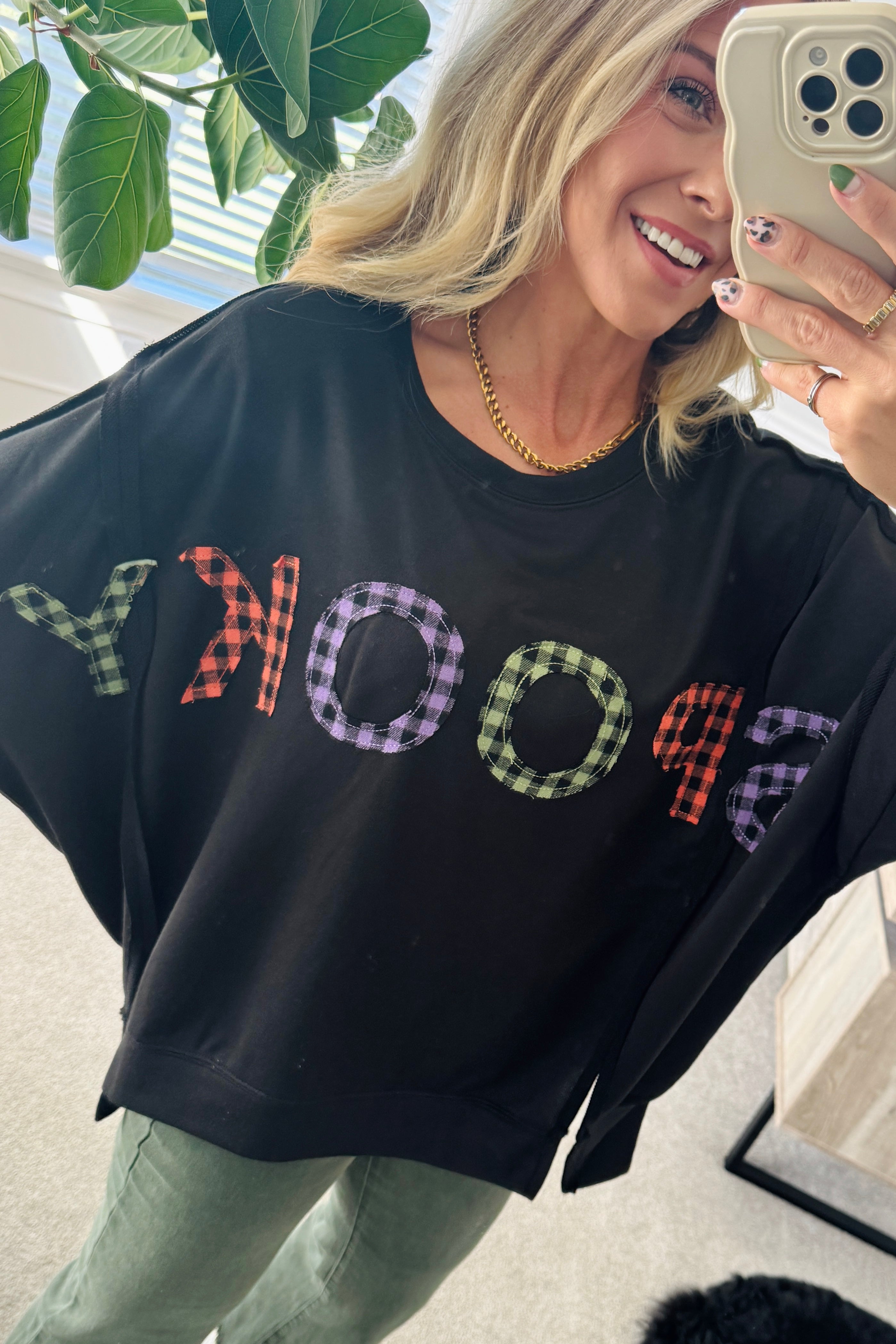 Blonde Woman Wearing a Halloween Theme Spooky Letter Top