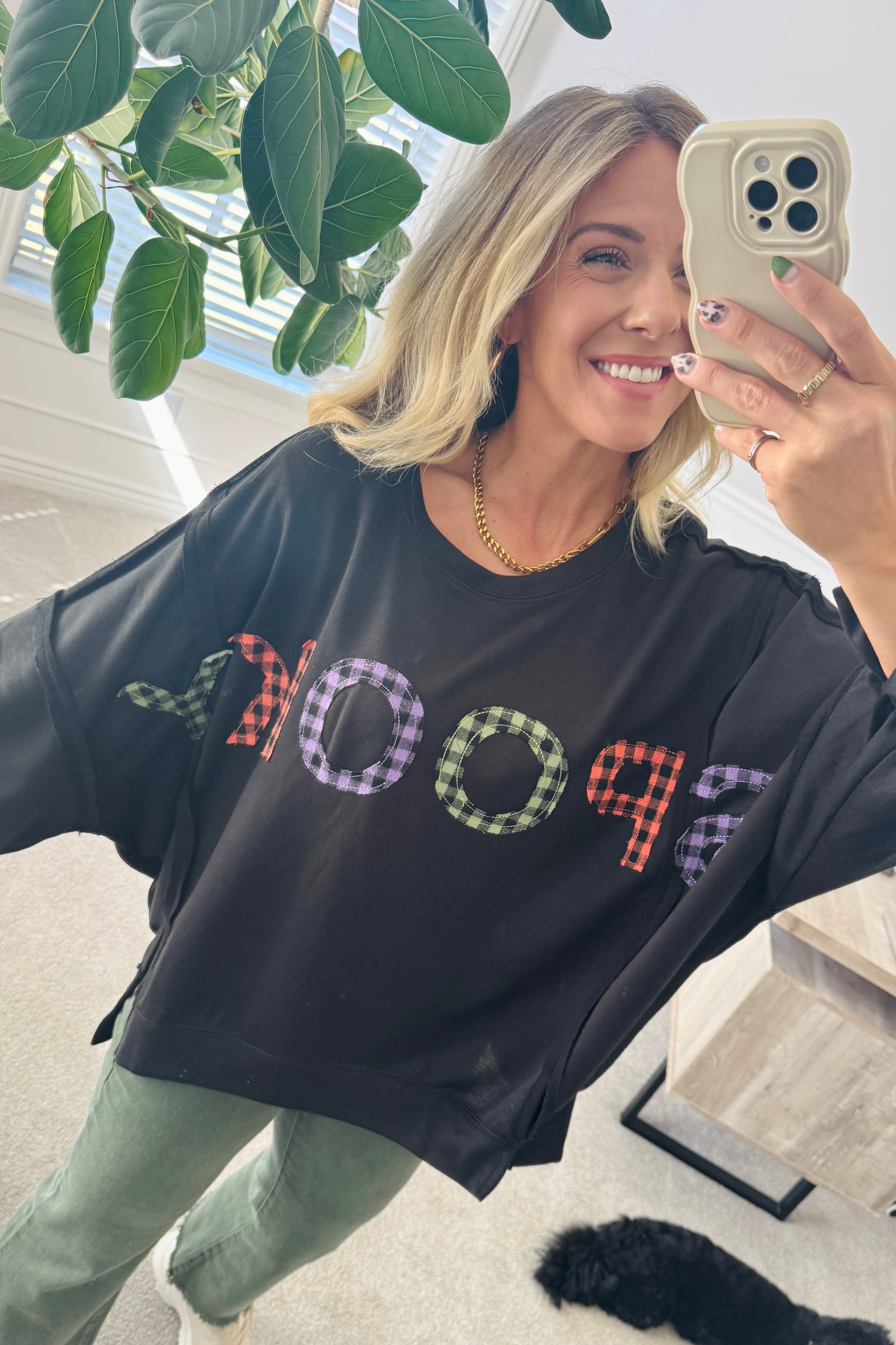 Blonde Woman Wearing a Halloween Theme Spooky Letter Top