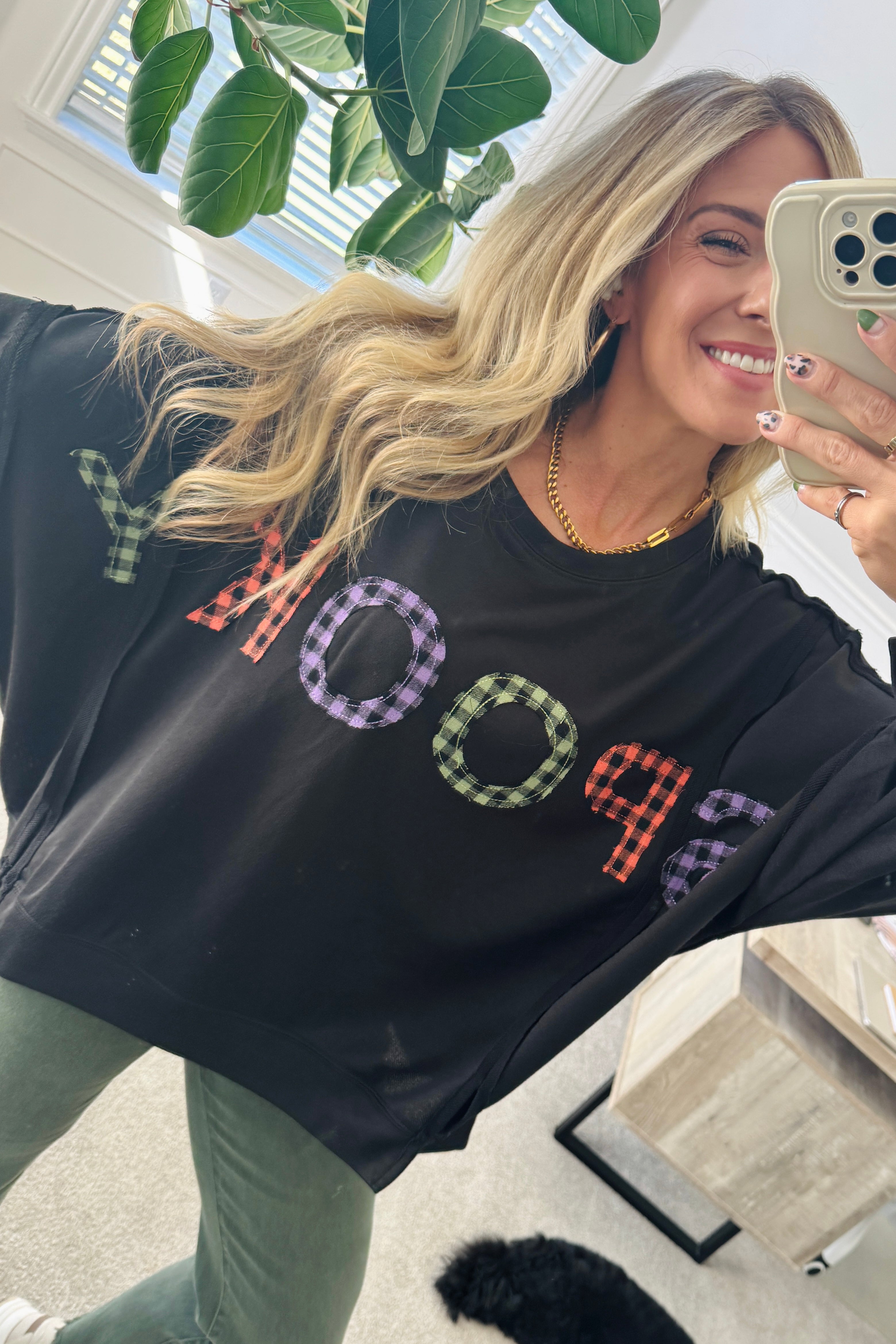 Blonde Woman Wearing a Halloween Theme Spooky Letter Top