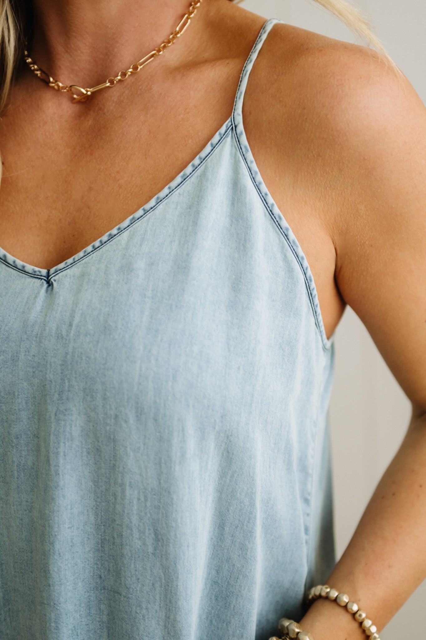Light blue sleeveless top worn by a person, with a neutral background