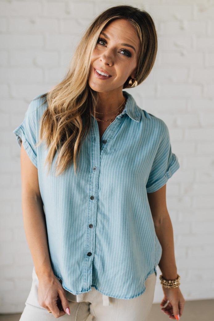 Blonde Woman Wearing a Striped Tencel Button Up Top W/ Rolled Sleeves.