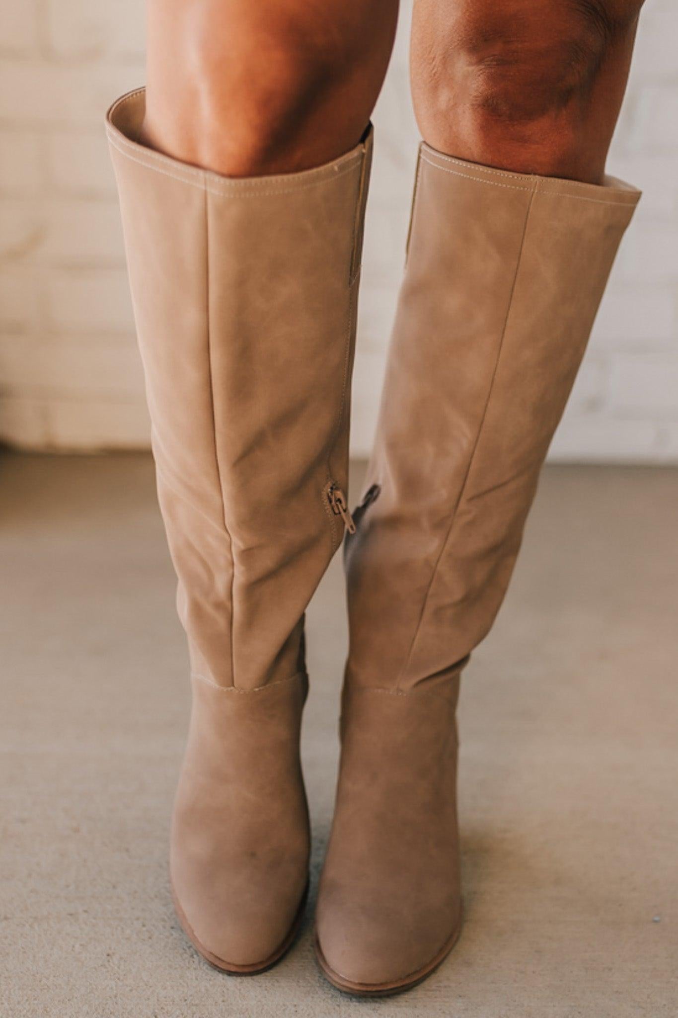 A beautiful tall soft faux suede boot on a stacked heel makes it a versatile staple in any wardrobe.