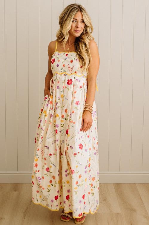 Woman wearing a floral dress against a plain background