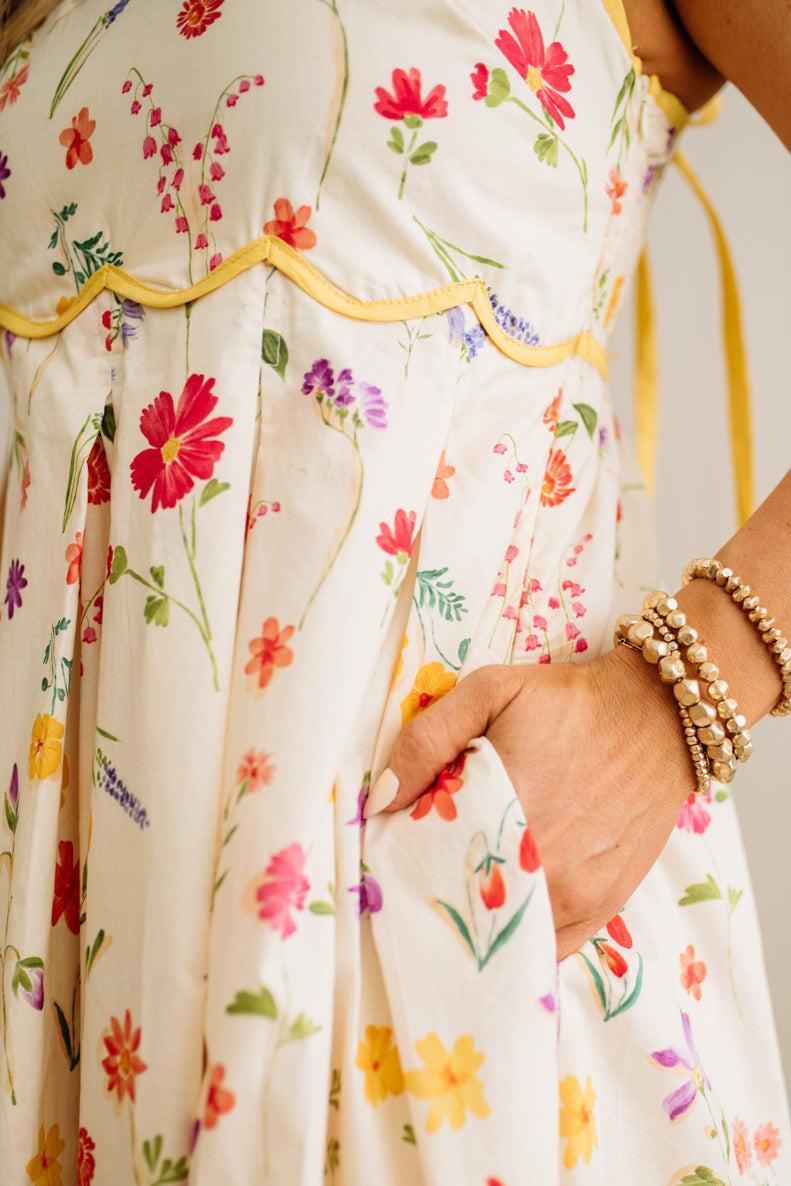 Close-up of a person wearing a floral dress with colorful flowers on a white background