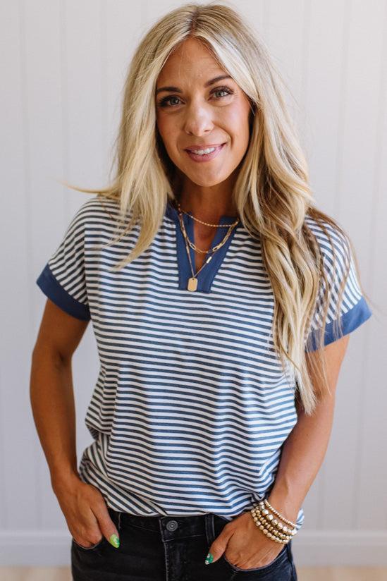 Woman wearing a striped shirt with a neutral background