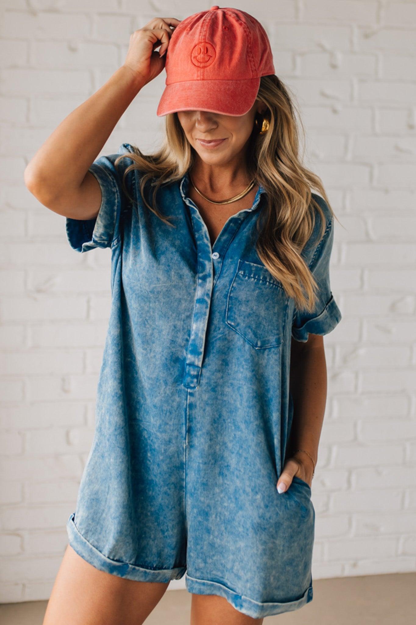 BLONDE WOMAN WEARING A TENCEL MINERAL WASHED HALF BUTTON SHIRTS ROMPER WITH POCKETS.