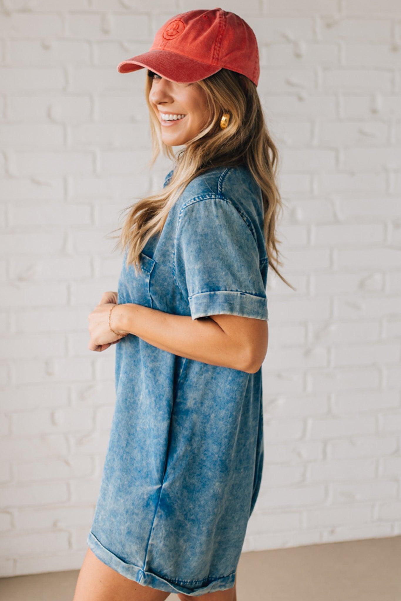 BLONDE WOMAN WEARING A TENCEL MINERAL WASHED HALF BUTTON SHIRTS ROMPER WITH POCKETS.