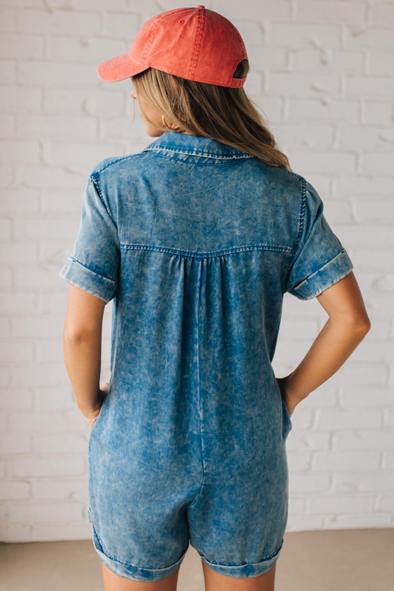 BLONDE WOMAN WEARING A TENCEL MINERAL WASHED HALF BUTTON SHIRTS ROMPER WITH POCKETS.