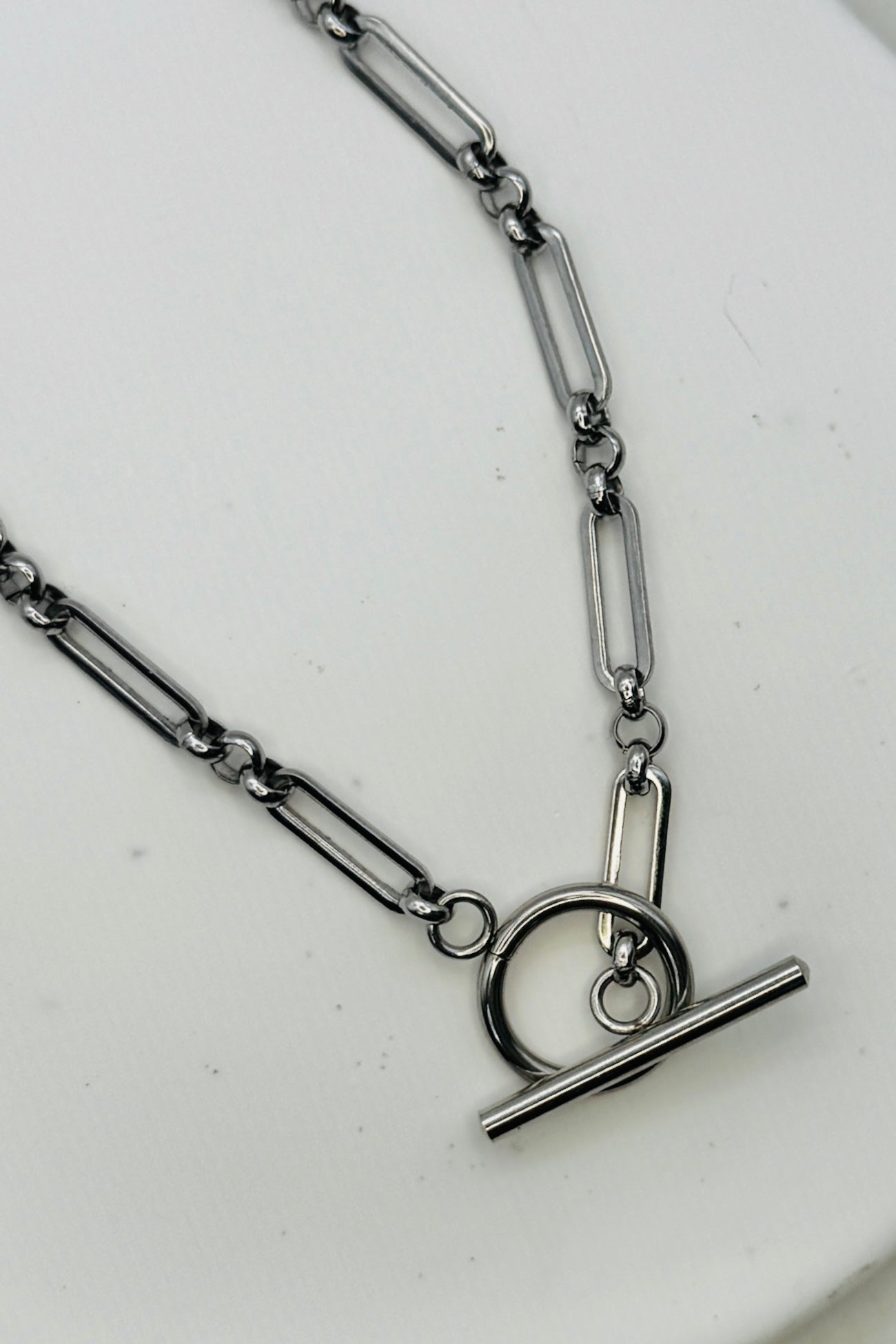 Silver chain necklace with a clasp on a white background