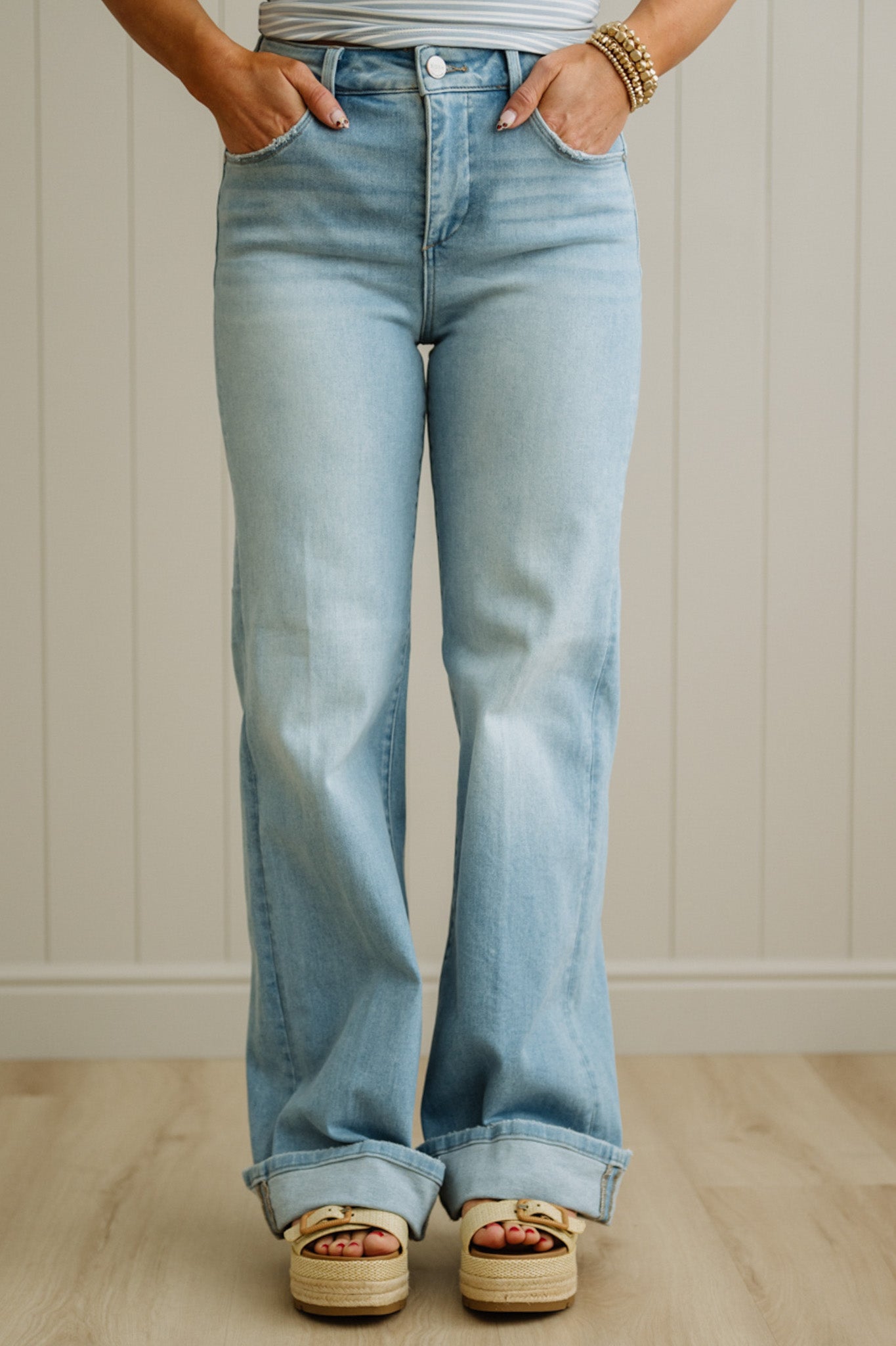 Light blue flared jeans worn by a person with a neutral background