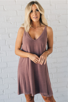 Blonde woman wearing a knee length ribbed kit dress.