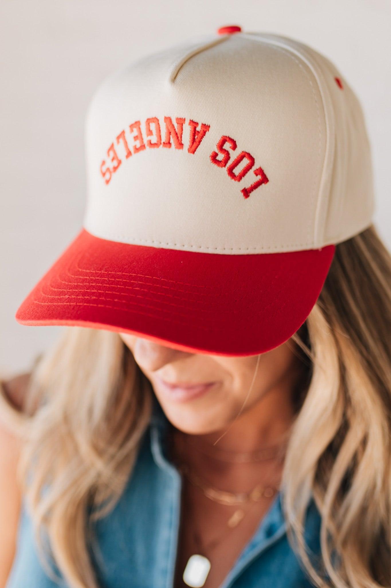 Blonde woman wearing a hat with LOS ANGELES embroidered upside down on a Vintage Two Tone Trucker Hat.